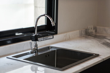 Close up of modern kitchen faucet and sink in kitchen room