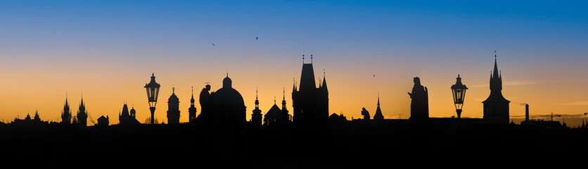 Fototapeta na wymiar Silhouette of the towers of the old town of Prague at sunrise