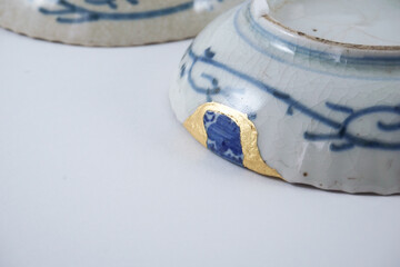 Kintsugi with different color mix , gold cracks Kintsugi, Kintsukuroi Japanese technique.