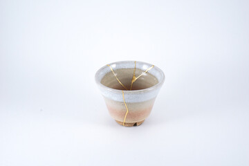 Antique Japanese Kintsugi, Beige and pink sake bowl , kintsugi the beauty of imperfection. Japanese artisan traditional Kintsukuroi method. Real gold restoration.