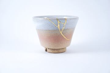 Antique Japanese Kintsugi, Beige and pink sake bowl , kintsugi the beauty of imperfection. Japanese artisan traditional Kintsukuroi method. Real gold restoration.
