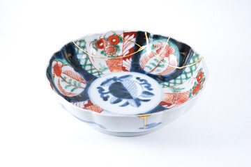 colourful Imari bowl restored with Kintsugi , gold cracks Kintsugi, Kintsukuroi Japanese technique.