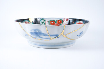 colourful Imari bowl restored with Kintsugi , gold cracks Kintsugi, Kintsukuroi Japanese technique.