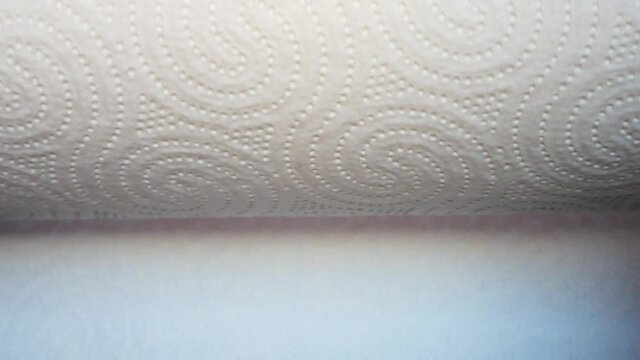Close-up of unwinding roll of paper towels