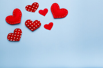 Blue background with red hearts, love concept, copy space, above