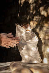 handcrafted bread-making sourdough hand flour sunlight ray of light  © simone