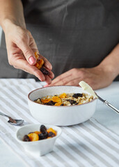 Porridge with dried fruit in the white plate
