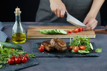 Steak and fresh vegetables and bottle of oil
