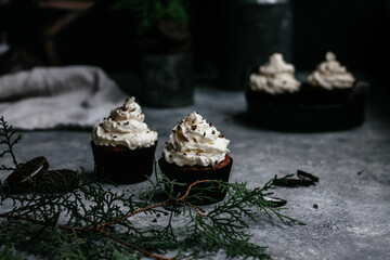 chocolate muffins with cream on gray background