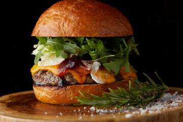 Fresh juicy burger on the black background