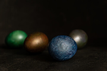 colorfull marble painted easter eggs on black background. Concept of minimal festive Easter backdrop