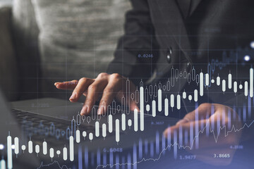 Woman typing the keyboard to research stock market to proceed right investment solutions. Internet trading and wealth management concept. Formal wear. Hologram Forex chart over close up shot.