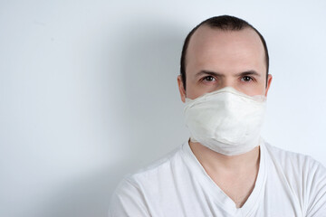 man in a medical mask on a white background, protection against viruses and bacteria