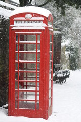 Red telephone box in snow