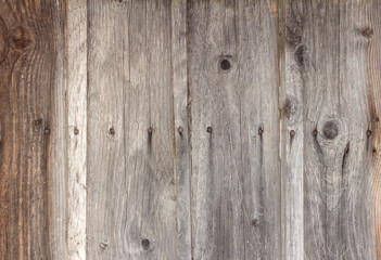 Old wooden background with cracks and nails, darkened and weathered boards.