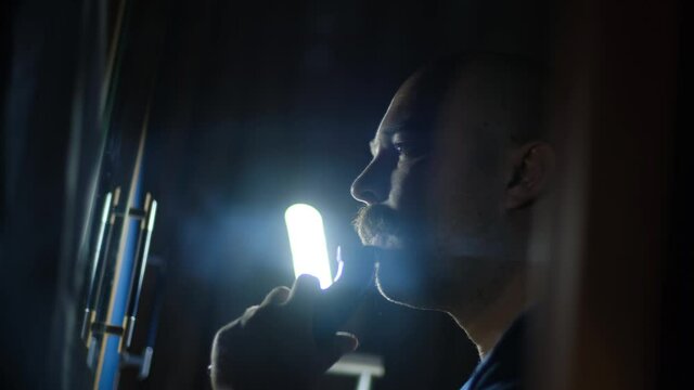 A man completely shaving off his beard and mustache, radically changing his image, close-up