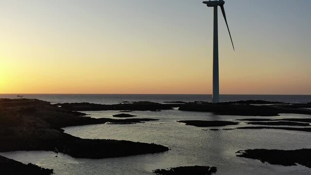 A video of a red sunset and a windmill