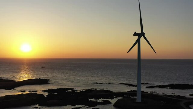 A video of a red sunset and a windmill