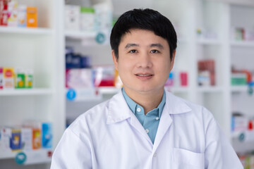 Portrait of men pharmacist asian standing Service in drugstore Thailand .