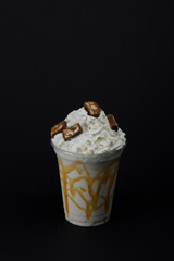 Coconut milkshake with sneakers and caramel close-up.