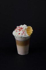 Raspberry latte with cream and waffle.