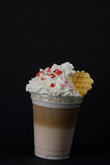 Raspberry latte with cream and waffle.
