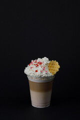 Raspberry latte with cream and waffle close-up.