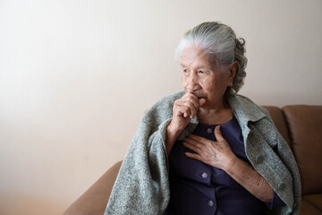 Asian senior ill female have a cough and sore throat. Causes of cough include common cold, flu,...
