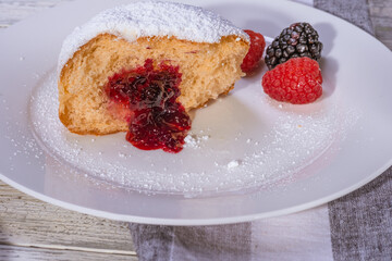 Berliner jelly filled doughnut with raspberry and blackberry.