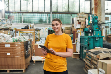 Young woman with tablet on garbage station background