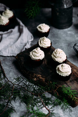Obraz na płótnie Canvas Chocolate cupcakes with creamy cream on a gray table