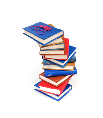 Stack of books in colour covers with white sheets isolated on a white background