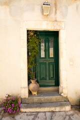 Fototapeta na wymiar Beautiful green door against a white wall.