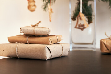 Christmas presents wrapped in ecological recycled paper on a table