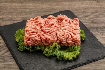 Raw pork minced meat over board