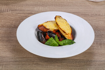 Mussels in the bowl with bread