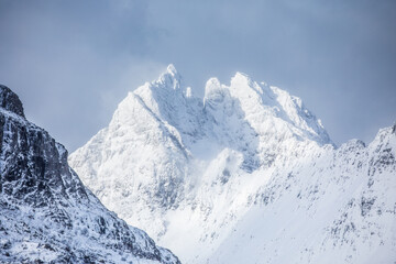 Beautiful landscape. Norway. Lofoeny. Snowy mountain against the sky.