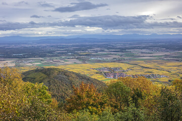 Fototapeta na wymiar Picturesque French landscape - aerial view from the Haut-Koenigsbourg Castle. Valley, small towns and mountains in the background in the Bas-Rhin departement of Alsace, France.