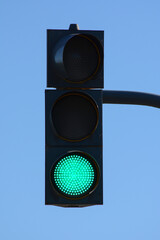 Traffic light with green light on, signal open to go ahead.