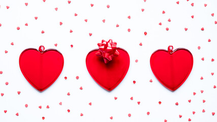 Valentine's day, love, romantic concept. Red hearts and bow on a white background.