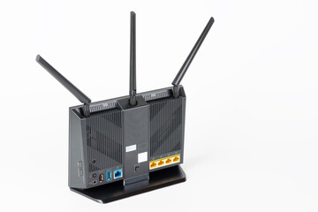 Rear view of gigabit dual-band   Wi-Fi router with  three antennas. Wireless device with five Gigabit Ethernet ports, ultrafast USB 3.1 port and  USB 2.0 port. 