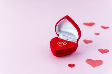 Gold ring in a box in the form of a heart. Valentine's Day, engagement. Horizontal orientation, copy space.
