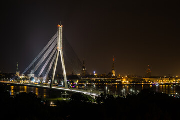 Fototapeta na wymiar bridge over the river at night with city skyline