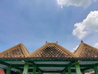 Tiled roof with bright blue sky