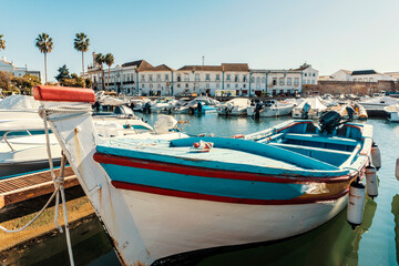 Obraz premium Old town of Faro with traditional wooden boat moored in marina, Portugal