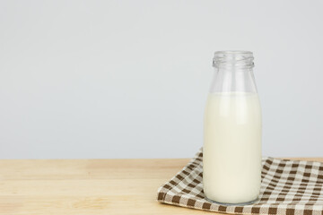 Bottles with fresh milk on a wooden table..Raw milk is high in calcium and protein to drink for all ages..Milk consumption nutritious and healthy dairy products concept.