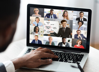 Unrecognizable african businessman at laptop having corporate meeting in office