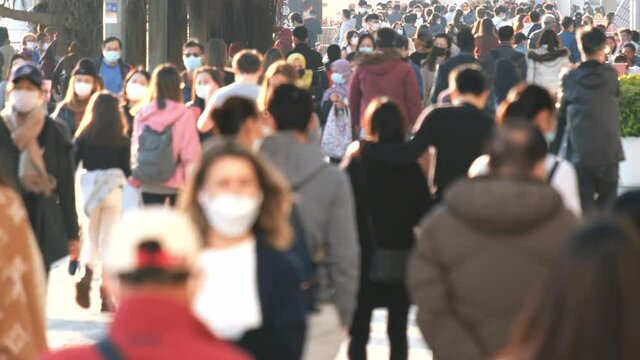 Slow motion of crowd people wearing medical face masks at metro in Hong Kong. Coronavirus concept	