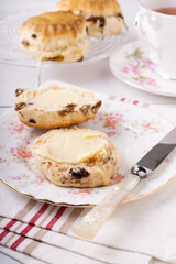 Scones a classic British cake filled with sultanas and raisins and often served buttered during afternoon tea