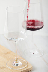 Red wine pouring to a white glass